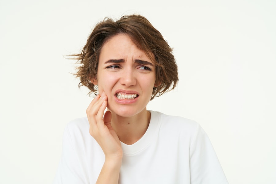 close-up-of-woman-has-a-toothache-touches-her-tee-2023-11-27-05-28-07-utc
