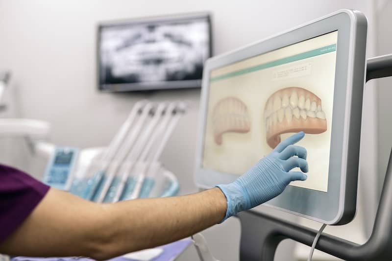 dental-clinic-worker-showing-x-ray-2023-11-27-05-18-34-utc