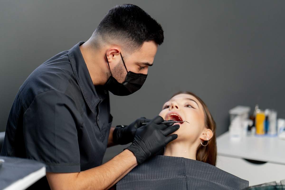 in-a-dental-office-male-dentist-examines-the-teeth-2024-04-20-00-05-50-utc